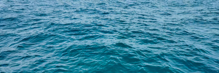 Fototapeta premium Tranquil deep blue ocean surface texture, ideal for maritime, summer vacation, and World Oceans Day themes