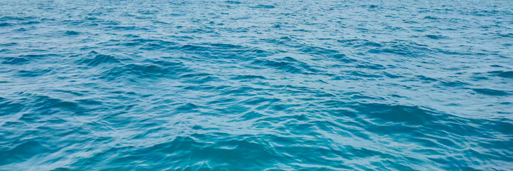 Tranquil deep blue ocean surface texture, ideal for maritime, summer vacation, and World Oceans Day themes