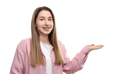 Portrait of smiling woman with dental braces showing something on white background