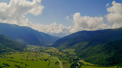 Breathtaking panoramic view of vibrant green meadows  under a blue sky, ideal for nature and travel...