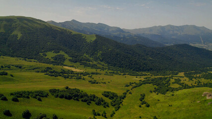 Breathtaking panoramic view of vibrant green meadows, ideal for nature and travel themes, Earth Day promotions