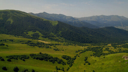 Breathtaking panoramic view of vibrant green meadows, ideal for nature and travel themes, Earth Day promotions