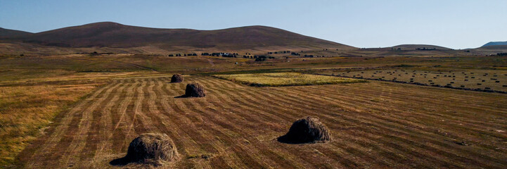 Rural landscape with round hay bales on a harvested field during autumn, related to agriculture and...