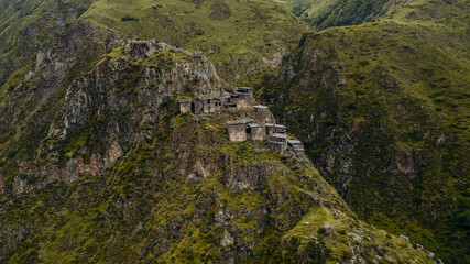 Aerial view of ancient mountain ruins in lush greenery, evoking history, archaeology, adventure...