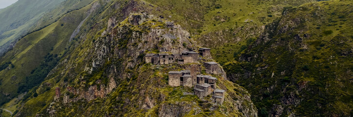 Aerial view of ancient mountain ruins in lush greenery, evoking history, archaeology, adventure...