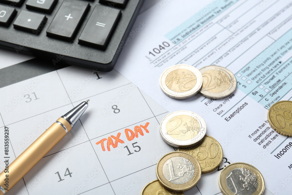 Wall mural calendar with date reminder about tax day, documents, coins, pen and calculator, closeup