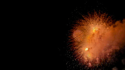 Spectacular white fireworks bursting against a dark night sky, ideal for New Year's Eve, Fourth of...