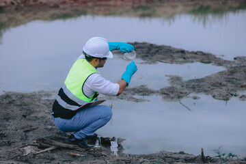 Asian Man experts analyze the water in a contaminated , environment ecology concept