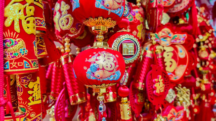 Vibrant traditional Chinese New Year decorations with red lanterns, embroidery and characters symbolizing luck and prosperity for holiday themes