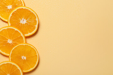 Slices of juicy orange and water on beige background, flat lay. Space for text