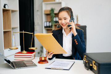 Asian lawyer woman working with a laptop and tablet in a law office. Legal and legal service...