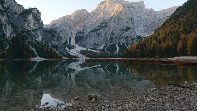Beautiful Lago di Braies (Lake Braies). Sunrise in Italian Dolomites. Pan Up Reveal