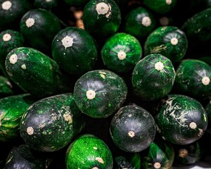 Closeup shot of stacked courgettes.