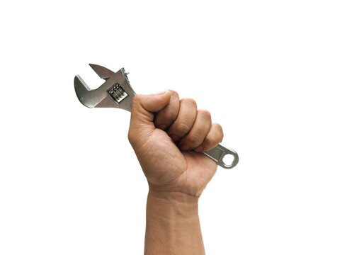A man's hand is holding a mechanic's tool called an adjustable wrench for use in mechanic work.  or industry in factories, is a device for tightening nut heads  Isolated on a white background.