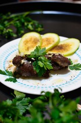 Chicken liver with slices of zucchini on the plate