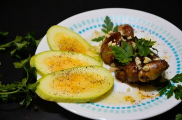 Chicken liver with slices of zucchini on the plate