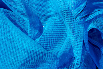 Close up of sun shade net with mesh lay on the ground with sunlight, Blue debris netting is the...
