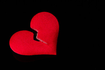 Red broken heart on black background
