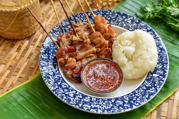 grilled pork and sticky rice  thai style on banana leaf, top view, thai called Moo ping	, bbq pork