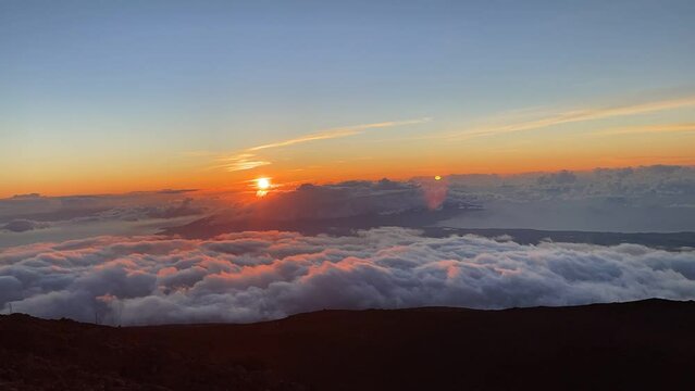 Timelapse footage of the clouds moving around the crater dormant Haleakala Volcano at sunset, Hawaii