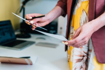 Closeup shot of a female comparing documents