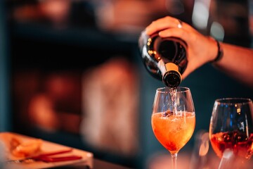 Closeup shot of a woman pouring alcohol in a glass