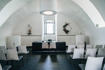 Simple hall for registration of the wedding with white chairs