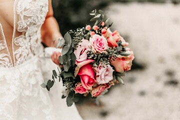 Young bride holding wedding bouquet