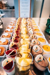 Vertical shot of different desserts in the buffet line for a wedding party