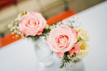 Shot of beautiful bouquets of rose flowers in glass vases