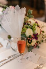 Vertical shot of a champagne glass on a wedding table