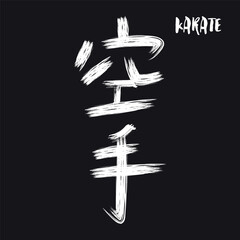 White hand drawn calligraphy hieroglyph KARATE isolated on black  background