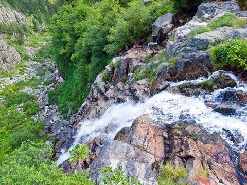 Aerial top view of Pancava Falls rushing down a hill in a beautiful green landscape