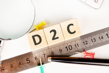 D2C - short for Direct-to-Consumer. D2C word written on wooden cubes next to the ruler