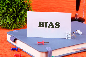 Personal opinions prejudice bias. Concept Bias on a business card standing on a business notebook