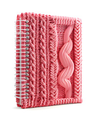 Spiral pink knitted pattern notebook isolated on white