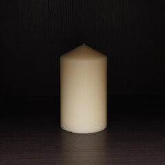 White candle on dark background