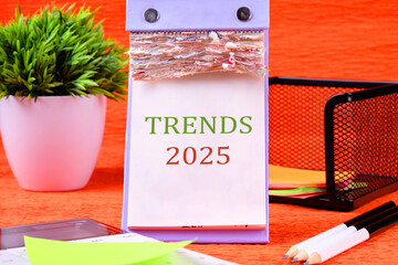 Text 2025 trends on a desktop calendar with tear-off sheets
