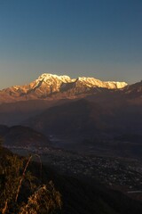 Vertical shot of the rocky Annapurna mountains at a calm sunrise