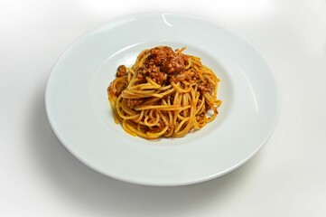 Gourmet plate of bolognese spaghetti isolated on a white background