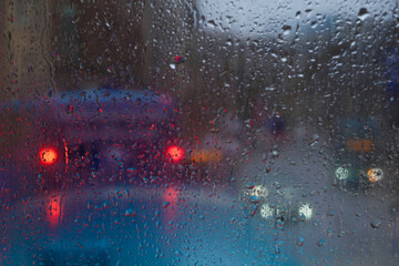 Window Rain and Blurred image of congested traffic, A serene blend of water and glass, Raindrops on...