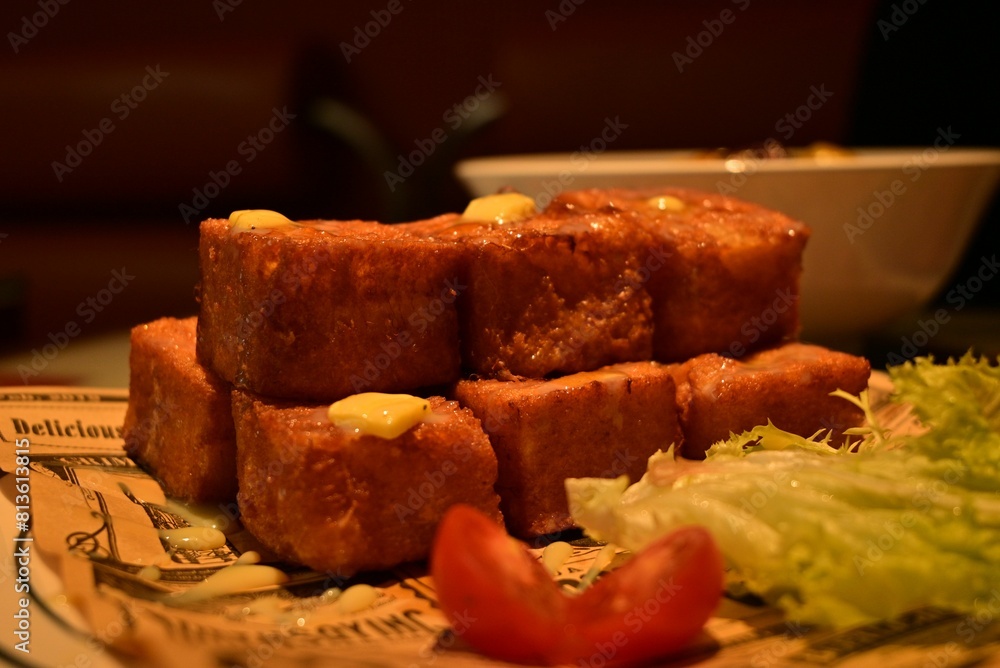 Wall mural closeup shot of french toast cubes, a piece of lettuce and tomatoes on an isolated background - Wall murals
