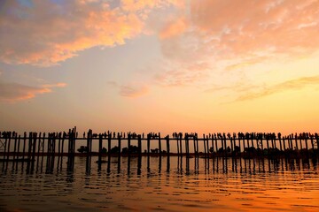 Fototapeta premium Sunset sky over peaceful sea with breakwaters
