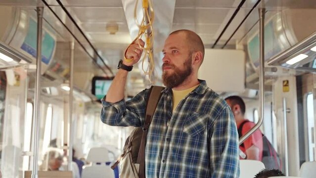 Adult with a backpack using metro train car. An adult heading to work, daily routine. Urban life in the morning as a citizen transportation on the subway. Public transport, ticket, pass