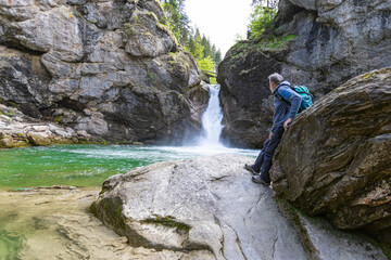 Germany, Bavaria, Allgaeu, male hiker in front of Buchenegger Wasserfalle, waterfall