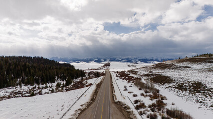 scenic highway through snow-capped mountains. Drone photo