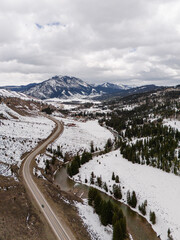 scenic highway through snow-capped mountains. Drone photo