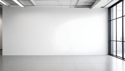 An empty room with a white wall and large windows, letting in natural light. The simplicity of the room provides a sense of space and brightness