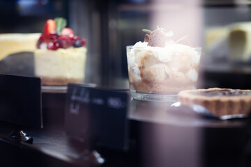Banoffee cake with caramel sauce in a glass cup and pie Place in the bakery shop ,bokeh light background