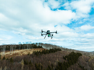 Aerial view of a drone moderning over forest, monitoring and analyzing in forestry management. Dron...